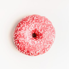 Pink donut on white background, top view
