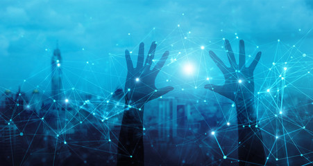 Hands of touching global network connection and data exchanges, internet communication on blue city background.