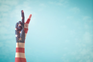 Victory symbol and American flag pattern on people's hand with for USA  election day concept