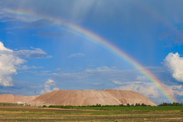 Soligorsk mountains. potash plant. Potash mountains near Soligorsk City. rainbow in the sky