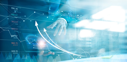 Businessman using tablet analyzing sales data and economic growth graph chart. Business strategy....