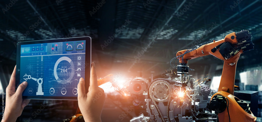 Fototapete Engineer check and control welding robotics automatic arms machine in intelligent factory automotive industrial with monitoring system software. Digital manufacturing operation. Industry 4.0