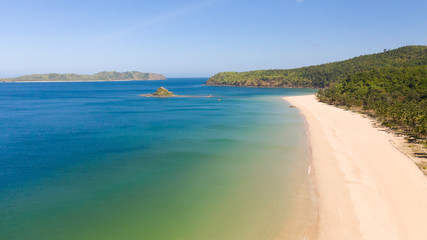 Wide white sand beach Nacpan Beach. El Nido, Palawan, Philippine Islands.Seascape with tropical beach and islands.Summer and travel vacation concept