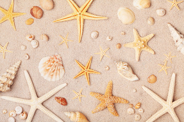 Heap of starfish and seashell on sand for summer holidays and travel background.