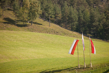 South Tirol flags on the air during the local celebration "Speckfest" in Val di Funes