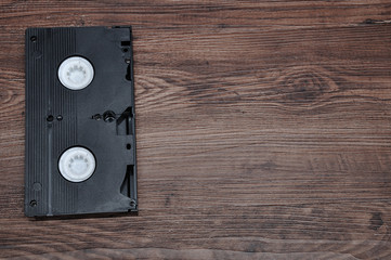 A video cassette isolated on a wooden background