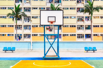 Iconic shot of Hong Kong basketball court with palms and colorful estate building