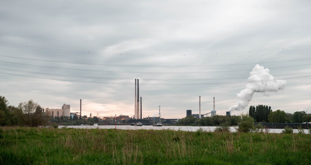 NRW/GERMANY - MAY 16, 2019: View of the industrial area with production plants next to the river rhine in Duisburg, Germany.