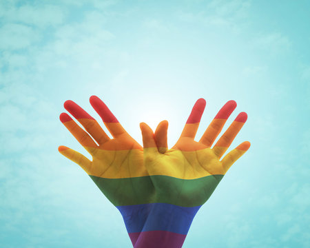 Rainbow flag pattern on people's hand in butterfly shape for Zero discrimination day concept