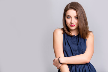 Obraz premium oung beautiful woman with long hair wearing blue dress happy smiling