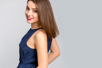 Obraz premium oung beautiful woman with long hair wearing blue dress happy smiling