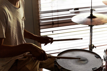 Drummer playing his rudiments on snare drum.