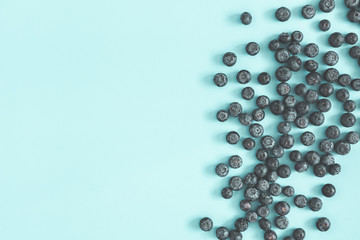 Blueberry on blue background. Flat lay, top view