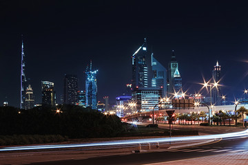 Night landscape with views of the skyscrapers and the Burj Khalifa from the side of the road