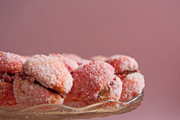 Arrangement of peaches shaped homemade cookies with flower on the vintage background.