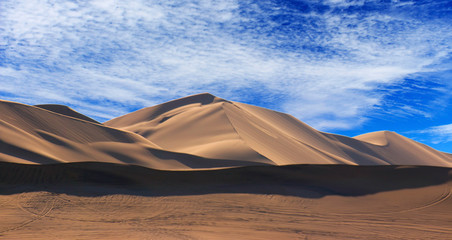 Golden sand dune 7 and white clouds on a sunny day