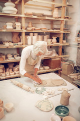 Top view of a skilled grey haired woman working