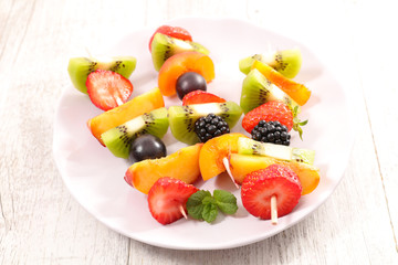 mixed fruit dessert on wood background