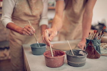 Close up of bottles with paint on the table