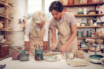 Handsome young man showing how to paint