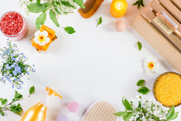 Spa and bath accessories with bath salts and beauty treatment products on white table. Wellness concept