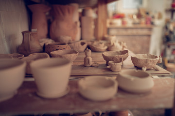 Close up of a shelf with clay dishes