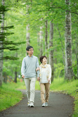 一本道を歩くシニア夫婦