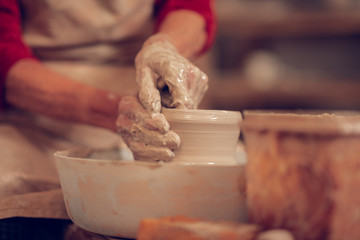 Close up of female hands in clay