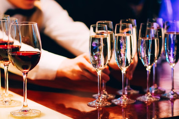 the bartender pours champagne. waiter pouring champagne at a party.