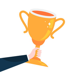 Hand holding big golden trophy cup. Idea of reward