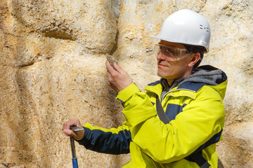 Fototapeta na wymiar geologist examines a sample of stone outdoor