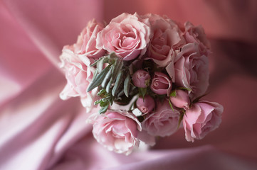 A small bouquet of pink roses. Wedding floristry. Delicate pastel colors.