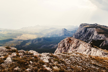 Fototapeta premium mountain landscape in the sun. mighty mountains. view from the mountains to the sea. rocky mountains and blue sky. Clouds hanging over the mountains.
