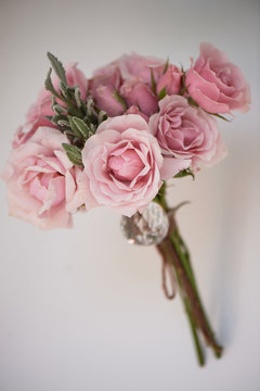 A small bouquet of pink roses. Wedding floristry. Delicate pastel colors.