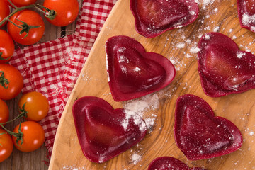 Red heart ravioli with tomato, mozzarella and basil. 