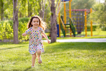 little happy girl on a walk on a summer evening at sunset in the park. Sisters