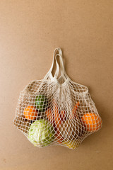 Fototapeta premium Eco friendly reusable mesh string knitted shopping bag with fruits and vegetables, zero waste