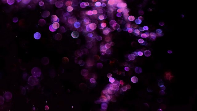 purple glitter in blur on a black background