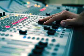 Professional audio mixing console with faders and adjusting knobs - radio / TV broadcasting