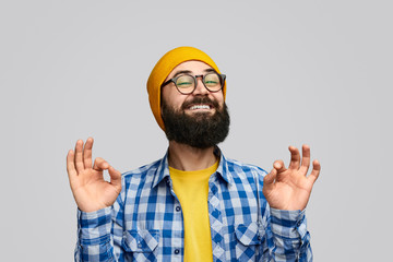Naklejka premium Glad hipster gesturing OK