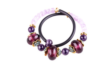 An amethyst bracelet with beads from a natural stone and a rubber cord