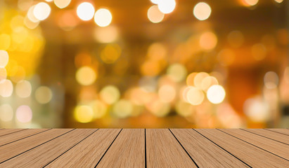 modern brown wood tabletop with blurred restaurant bar cafe light color background for promote and advertise product on display	