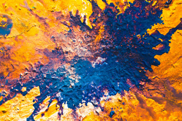 Abstract art texture background. River in desert design. Orange and blue paint mixture splash with...