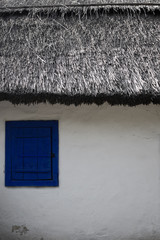 Fototapeta na wymiar Countryside house with blue window