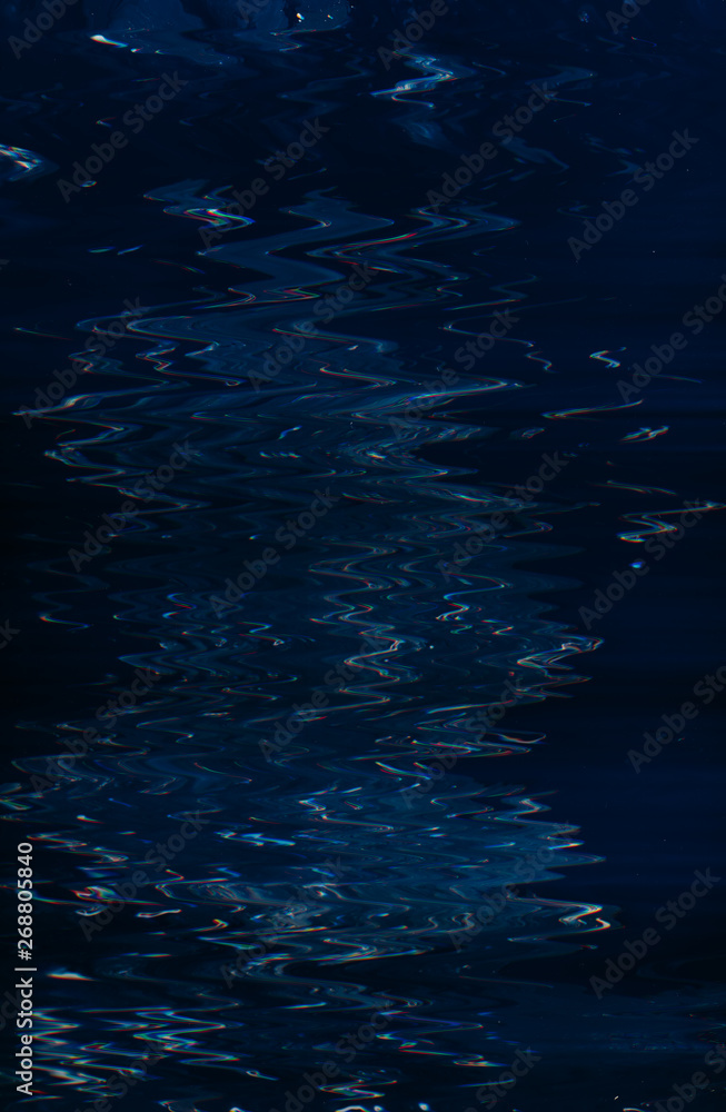 Wall mural abstract dark blue paint background. smooth glossy liquid fluid surface. water expanse. ripples effe