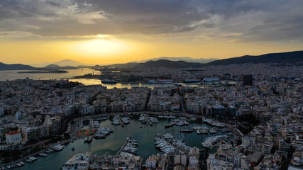 Aerial drone bird's eye view of famous port of Piraeus one of the largest in Europe at sunset with beautiful golden colours, Attica, Greece