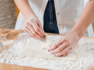 Woman baking. Hands in flour with flat pastry dough closeup. Making cookies. Culinary classes courses. Home bake hobby.