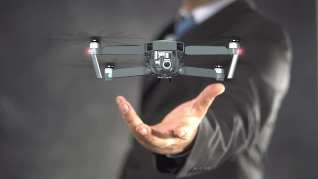 Businessman on blurred background using modern drone