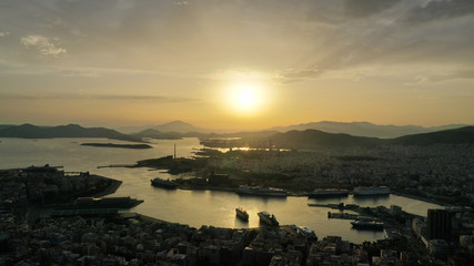 Aerial drone bird's eye view of famous port of Piraeus one of the largest in Europe at sunset with beautiful golden colours, Attica, Greece