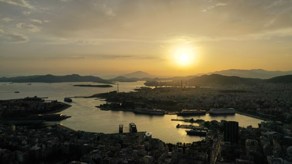 Aerial drone bird's eye view of famous port of Piraeus one of the largest in Europe at sunset with beautiful golden colours, Attica, Greece